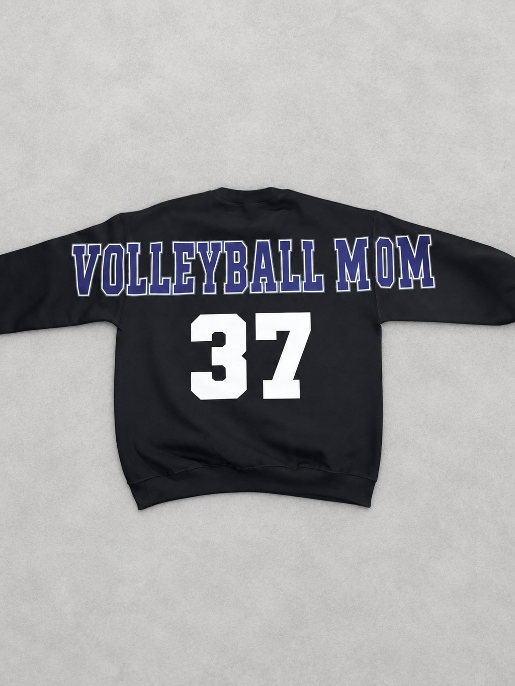Clean back product photo of black Volleyball Mom sweatshirt with navy and white lettering and player number 37
