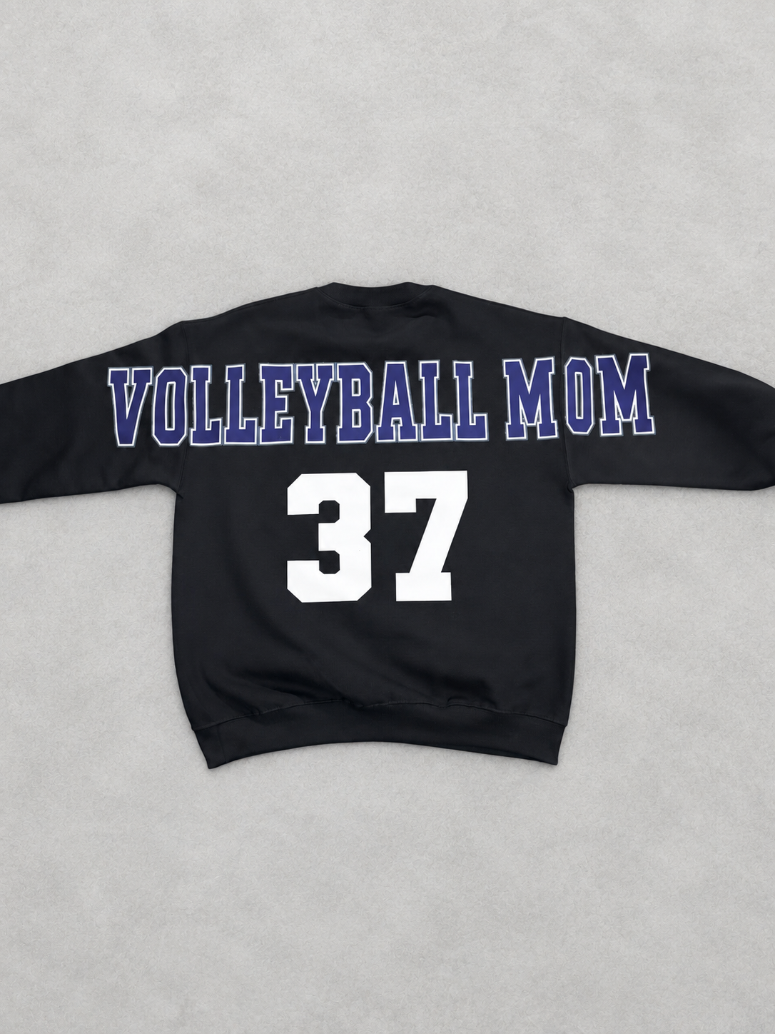 Clean back product photo of black Volleyball Mom sweatshirt with navy and white lettering and player number 37